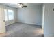 Bedroom with neutral carpeting, a ceiling fan, and a large window with blinds at 8656 Webb Rd, Riverdale, GA 30274