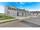 Street view of new townhouses showing garages and sidewalks, with well-kept landscaping at 8656 Webb Rd, Riverdale, GA 30274