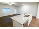 Bright, open kitchen with white cabinets and stainless steel appliances at 8656 Webb Rd, Riverdale, GA 30274