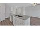 Open concept kitchen island featuring gray granite countertops and hardwood flooring at 8656 Webb Rd, Riverdale, GA 30274