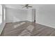 Bright living room featuring modern wood flooring, large windows, and a stylish ceiling fan at 8656 Webb Rd, Riverdale, GA 30274