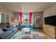 Stylish living room with a blue sofa, colorful rug, and quirky, comfortable, mid-century modern design at 1976 Northside Nw Dr, Atlanta, GA 30318