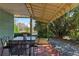 Comfortable side porch with a table, surrounded by lush greenery, perfect for outdoor dining at 1976 Northside Nw Dr, Atlanta, GA 30318