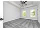 Spacious bedroom featuring large windows, trey ceiling, and plush gray carpeting for comfort and style at 316 Oak Arms Way, Woodstock, GA 30188