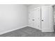Cozy bedroom with soft gray carpet and a double door closet at 316 Oak Arms Way, Woodstock, GA 30188