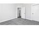 Clean, neutral bedroom with light gray carpet and white trim, leading to bathroom at 316 Oak Arms Way, Woodstock, GA 30188