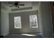 Bright bedroom with neutral walls, carpet, ceiling fan and two windows at 316 Oak Arms Way, Woodstock, GA 30188