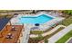 Aerial view of a sparkling community pool with lounge chairs, umbrellas, and a nearby pergola at 316 Oak Arms Way, Woodstock, GA 30188