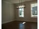 Dining area showcasing hardwood floors, a modern chandelier, and abundant natural light through large windows at 316 Oak Arms Way, Woodstock, GA 30188
