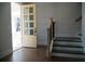 Bright entryway with hardwood floors, staircase, and a charming glass-paneled front door at 316 Oak Arms Way, Woodstock, GA 30188