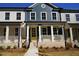 Charming townhouse featuring a welcoming porch, brick accents, and a vibrant yellow front door at 316 Oak Arms Way, Woodstock, GA 30188