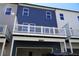 New townhouse shows a two car garage, deck with white railings, and a combination of gray and navy siding at 316 Oak Arms Way, Woodstock, GA 30188