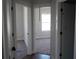Bright hallway showcasing newly installed doors, leading to carpeted bedrooms with natural light at 316 Oak Arms Way, Woodstock, GA 30188