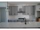 Stylish kitchen featuring gray cabinets, stainless steel appliances, white subway tile, and marble countertops at 316 Oak Arms Way, Woodstock, GA 30188