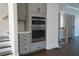 Modern kitchen appliances featuring built-in oven and microwave, complemented by gray cabinets and drawers at 316 Oak Arms Way, Woodstock, GA 30188