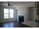 Cozy living room with a fireplace, large window, hardwood floors, and modern finishes at 316 Oak Arms Way, Woodstock, GA 30188