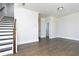 Spacious living room with hardwood floors, staircase, neutral paint, and access to a powder room at 316 Oak Arms Way, Woodstock, GA 30188