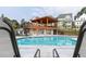 Community pool with clear blue water, lounge chairs, and a covered pavilion at 316 Oak Arms Way, Woodstock, GA 30188
