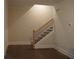 Staircase with dark wood floors, white trim, and wrought iron railing at 316 Oak Arms Way, Woodstock, GA 30188