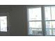 Bright room features large windows with white trim and a door leading to an outdoor balcony at 316 Oak Arms Way, Woodstock, GA 30188