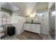 Light filled bathroom with double vanity, patterned window shade, and glass enclosed shower at 787 Martina Ne Dr, Atlanta, GA 30305