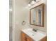 Cozy bathroom featuring a wood-trimmed mirror, single sink vanity, and neutral walls at 848 Capitol View Nw Ave, Atlanta, GA 30318