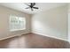 This bedroom features dark wood laminate flooring, a ceiling fan, and a bright window at 848 Capitol View Nw Ave, Atlanta, GA 30318