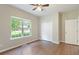 This bedroom has a ceiling fan, dark wood laminate flooring, and a large window at 848 Capitol View Nw Ave, Atlanta, GA 30318