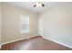 This bedroom features dark wood laminate flooring, a ceiling fan, and a bright window at 848 Capitol View Nw Ave, Atlanta, GA 30318