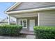 Inviting covered front porch with green hedges, leading to a white security door at 848 Capitol View Nw Ave, Atlanta, GA 30318