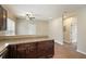 Kitchen with wooden cabinets, countertops, and an adjacent room featuring a ceiling fan and natural light at 848 Capitol View Nw Ave, Atlanta, GA 30318