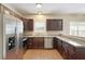 Bright kitchen featuring stainless steel appliances, dark wood cabinetry, and durable countertops for easy maintenance at 848 Capitol View Nw Ave, Atlanta, GA 30318