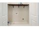 Dedicated laundry room featuring tiled floors and shelving space for efficient organization at 848 Capitol View Nw Ave, Atlanta, GA 30318