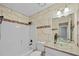 Bathroom with tiled walls, modern fixtures, and a glass vessel sink at 10846 Sunfield Way, Hampton, GA 30228