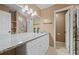 Bathroom featuring double sinks, granite counters, tile floors, and ample lighting at 10846 Sunfield Way, Hampton, GA 30228