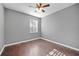 Bedroom featuring sleek hardwood floors, a ceiling fan, and a window at 10846 Sunfield Way, Hampton, GA 30228