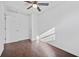 Bedroom featuring sleek hardwood floors, a ceiling fan, and a window at 10846 Sunfield Way, Hampton, GA 30228