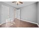 Bedroom with modern grey walls, sleek floors, and a ceiling fan at 10846 Sunfield Way, Hampton, GA 30228