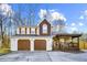 Charming two-story home with two-car garage, stone accents, covered porch, and well-manicured yard at 10846 Sunfield Way, Hampton, GA 30228