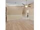 Bright living room featuring wood flooring, a ceiling fan, and staircase to the upper level at 10846 Sunfield Way, Hampton, GA 30228