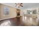 Large open concept living room with a fireplace and adjacent kitchen and dining area at 10846 Sunfield Way, Hampton, GA 30228