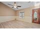 Bright and airy living room featuring modern flooring, neutral paint, and a stylish front door at 10846 Sunfield Way, Hampton, GA 30228