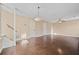 Spacious living room with hardwood flooring, two entryways, and neutral wall colors at 10846 Sunfield Way, Hampton, GA 30228