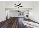 Large living room featuring modern ceiling fan, dark hardwood floors and stone fireplace at 117 Holt Ne Rd, Marietta, GA 30068