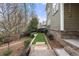 Backyard featuring a custom putting green, stone steps, and mature trees at 2434 Soft Maple St, Atlanta, GA 30360