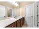 Bathroom featuring a long vanity with a white countertop, dark cabinets, and a large mirror at 2434 Soft Maple St, Atlanta, GA 30360