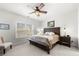 Bright bedroom featuring a wooden bed frame, ceiling fan, and natural light from a large window at 2434 Soft Maple St, Atlanta, GA 30360