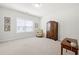 Spacious carpeted room with a ceiling fan, natural light, and traditional furnishings at 2434 Soft Maple St, Atlanta, GA 30360