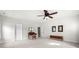 Spacious room with neutral walls, carpet flooring, ceiling fan, and two exterior doors at 2434 Soft Maple St, Atlanta, GA 30360