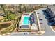 Overhead shot of the neighborhood pool, surrounded by trees, with cabanas and parking at 2434 Soft Maple St, Atlanta, GA 30360